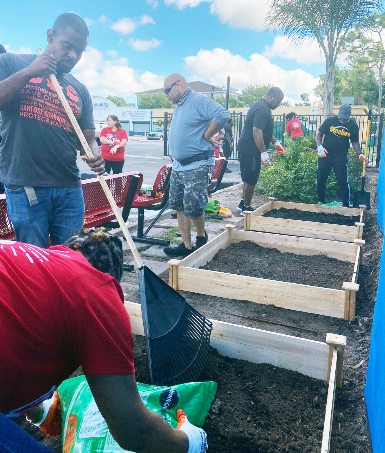 Event volunteers work to construct five raised garden beds.
